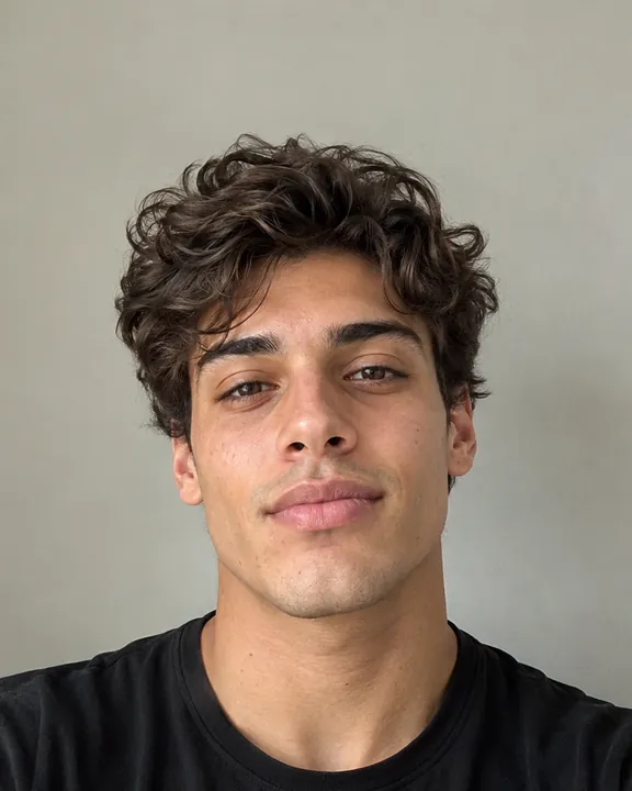 Man with medium-length curly hair before any haircut, the original photo